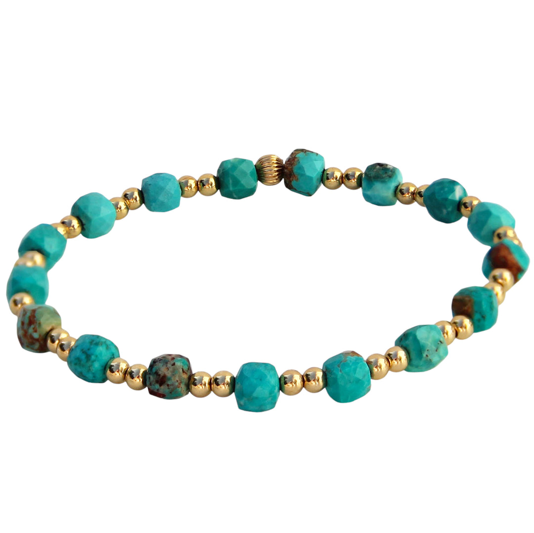 A handcrafted bracelet featuring vibrant turquoise gemstone cube shaped beads paired with gold beads, designed to inspire intuition, emotional expression, and personal happiness.