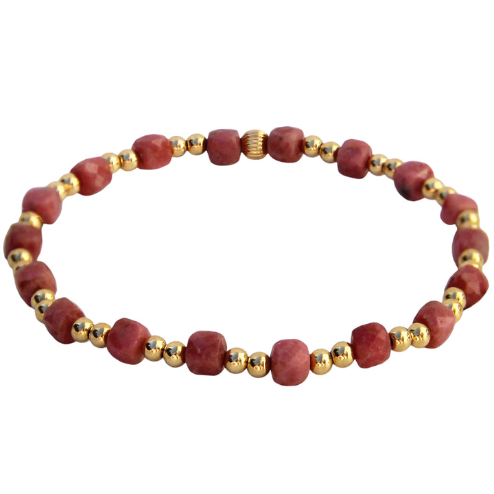 A handcrafted bracelet featuring faceted rhodonite cubed gemstones in soft pink hues, accented with gold beads, designed to inspire love, forgiveness, and emotional healing