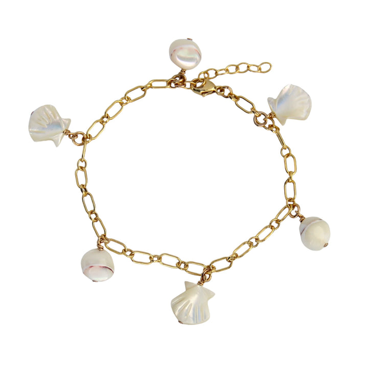 A delicate gold bracelet featuring mother-of-pearl shell charms and pearl nugget accents. The bracelet has a gold chain with an adjustable clasp, combining an boho seaside-inspired design with a timeless look.