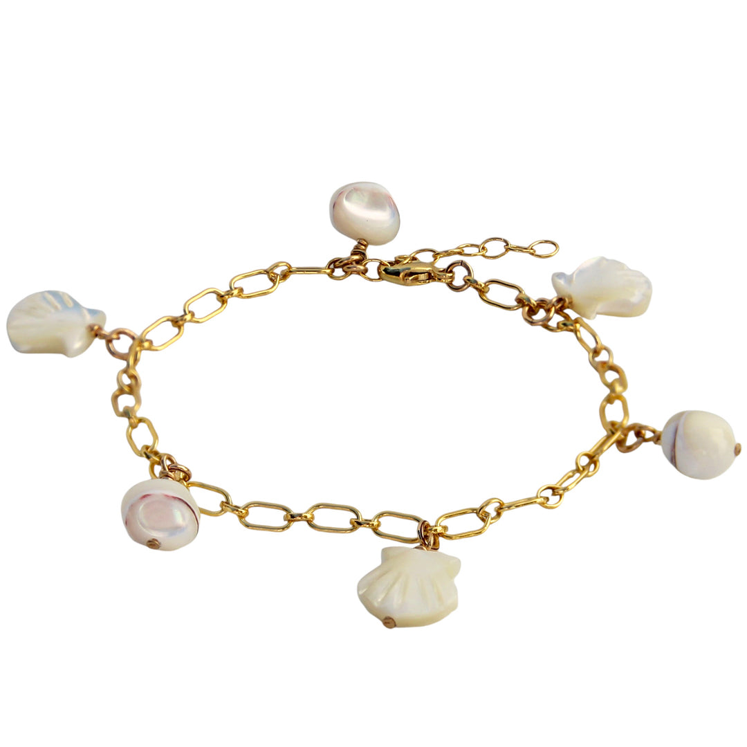 A gold chain bracelet adorned with mother-of-pearl shell charms and pearl nugget bead accents. This ocean-inspired design exudes boho vibes and brings a touch of seaside charm to any outfit.