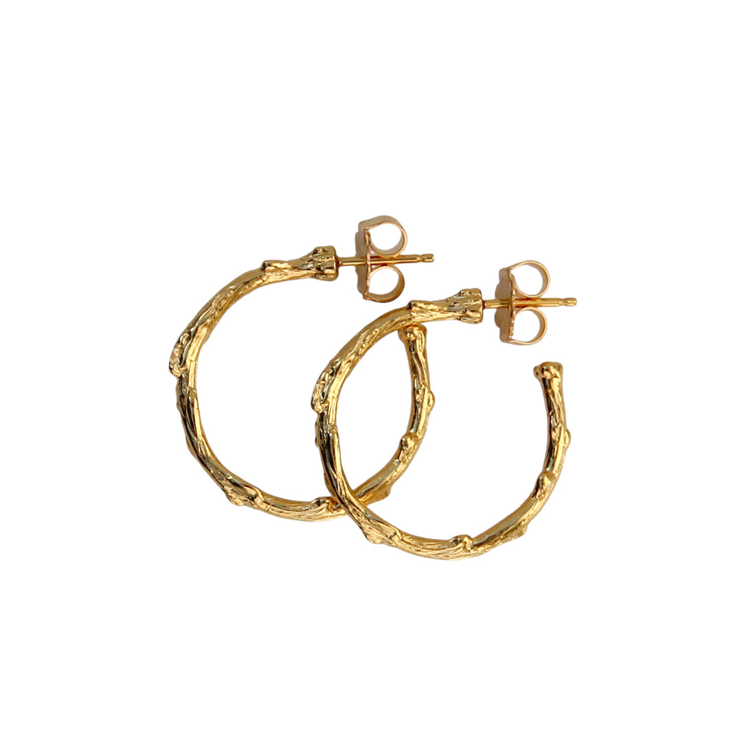 Product image of medium-sized Olive Branch Hoop Earrings in gold by Blooming Lotus Jewelry, featuring a branch design inspired by nature, symbolizing peace and resilience. Perfect statement hoops for a boho-chic style.