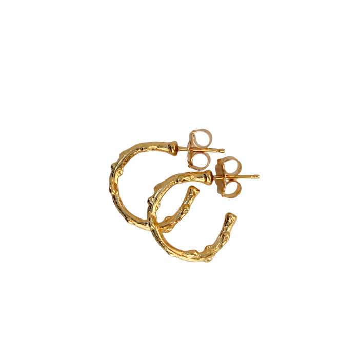 Close-up image of small-sized gold hoop earrings with a branch-inspired texture