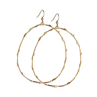 Pair of large gold hoop earrings with a branch-inspired texture, designed in an elongated loop shape