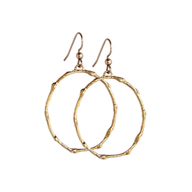 Pair of medium-sized gold hoop earrings with a branch-inspired texture, designed in an elongated loop shape