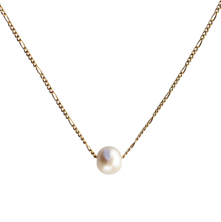 Product photo of a delicate gold Figaro chain necklace featuring a single, luminous freshwater pearl that slides freely along the chain, displayed against a white background.