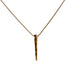 Close-up of a gold necklace featuring a sleek, spear-shaped pendant with a textured finish, hanging from a delicate gold chain, displayed against a white background.