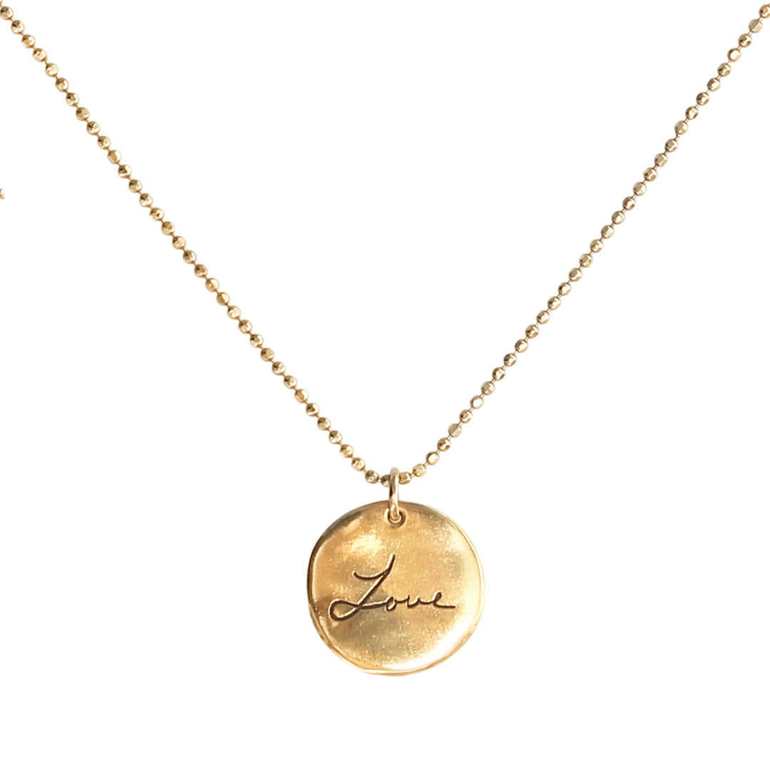 Gold necklace featuring a round pendant engraved with custom handwriting that reads 'Love,' suspended on a delicate beaded chain – Written With Love Necklace by Blooming Lotus Jewelry