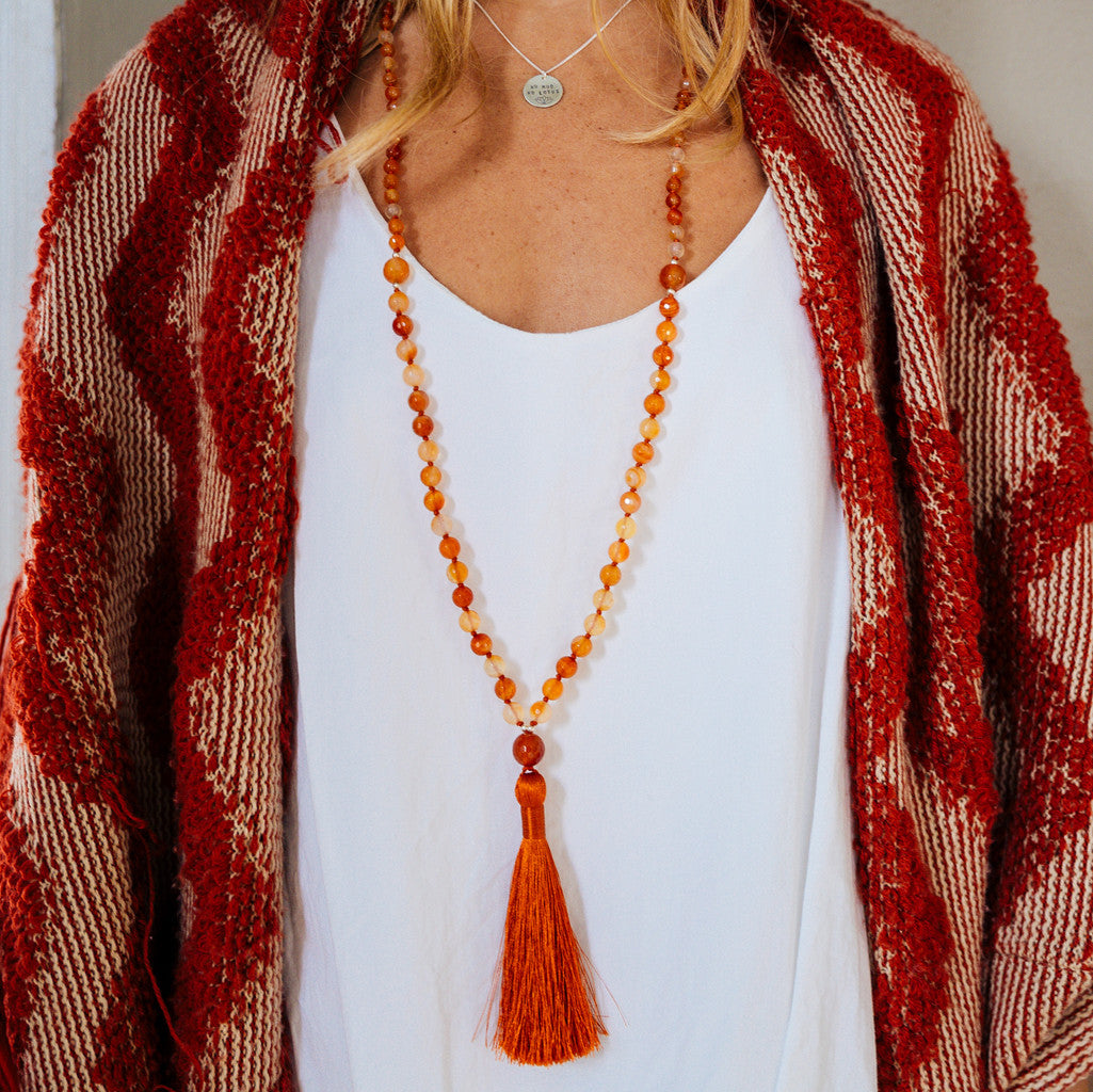 Carnelian gemstone boho mala beads on model with red sweater