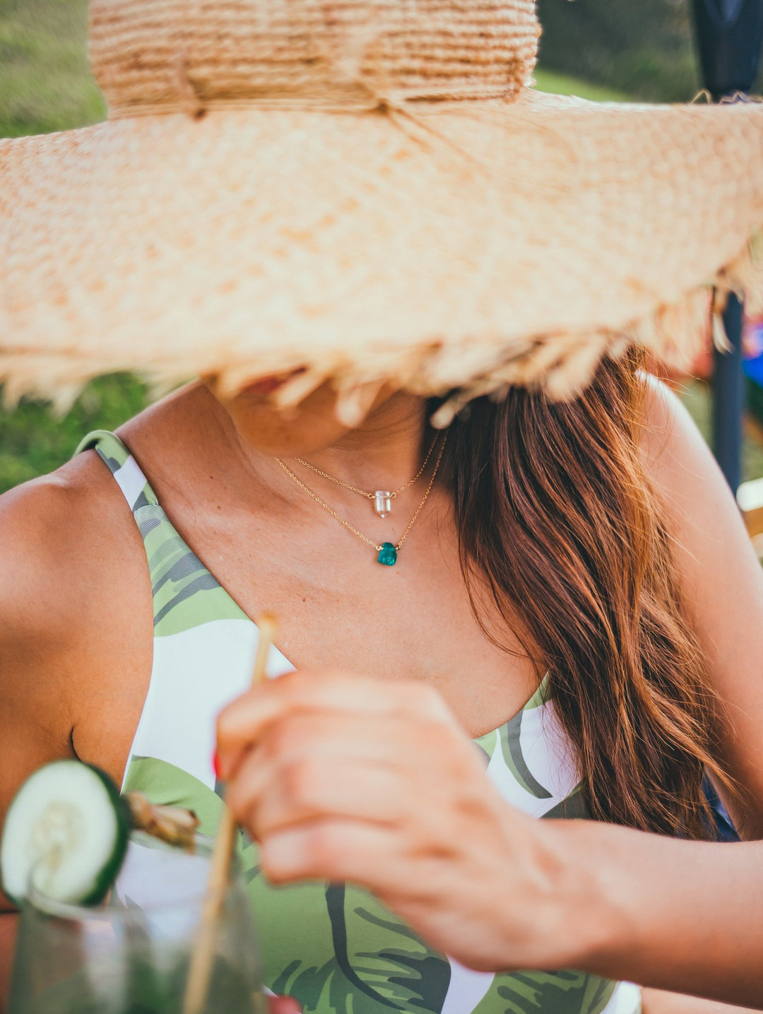 Crystal Necklaces - Clear Quartz - Apatite - gold on model with straw hat - Blooming Lotus Jewelry