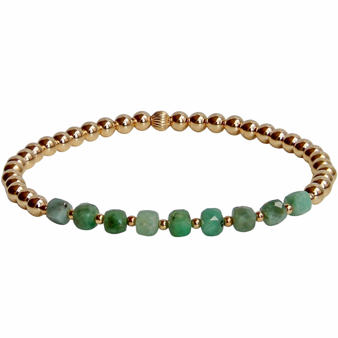 Gold beaded stretch bracelet featuring faceted emerald gemstones in rich green hues. A vibrant and timeless piece, perfect for adding a touch of natural beauty to any jewelry stack.