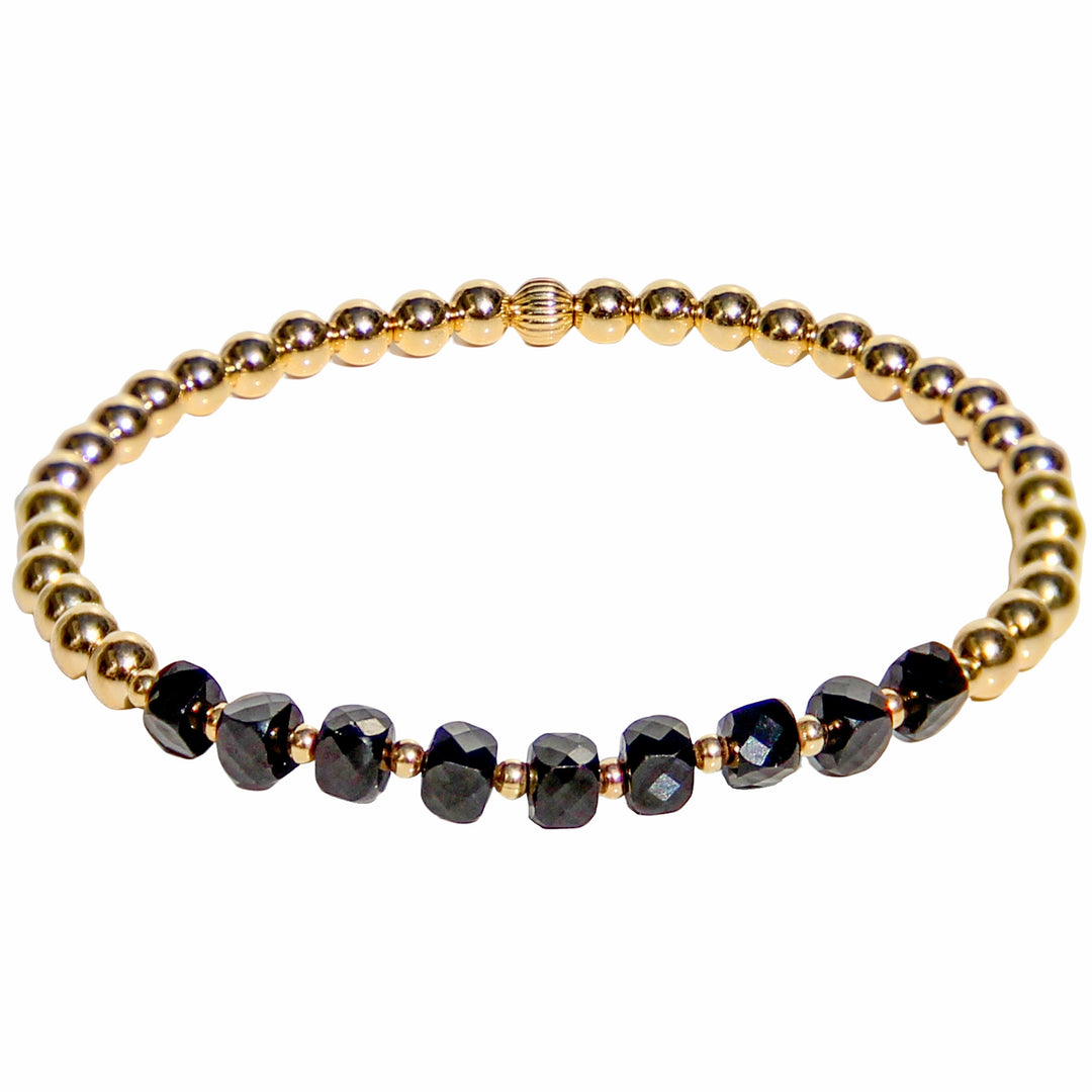 Gold beaded stretch bracelet featuring faceted black spinel gemstones, known for their grounding and protective energy. A sleek and versatile piece that adds a bold touch to any jewelry stack.