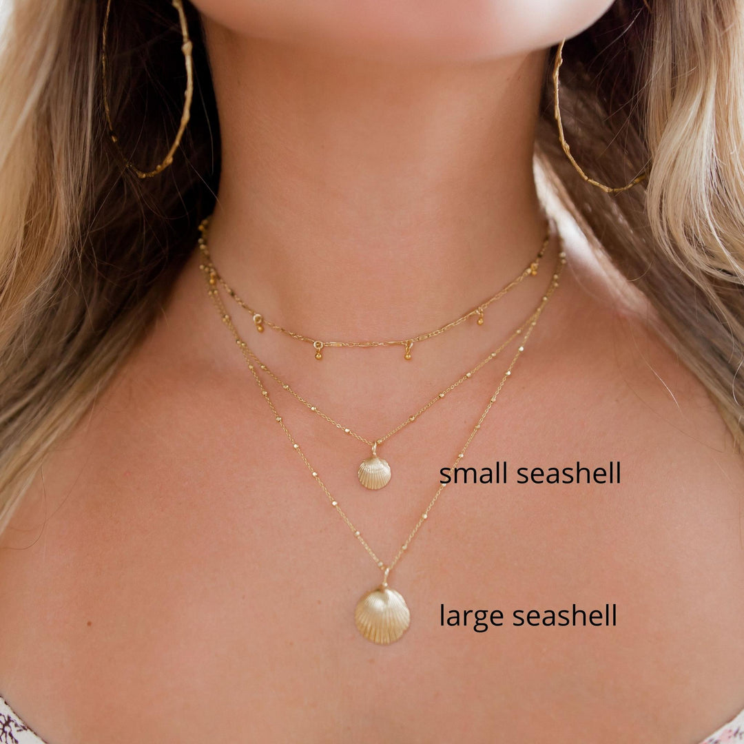 small and large shell necklaces layered on models neck - Blooming Lotus Jewelry