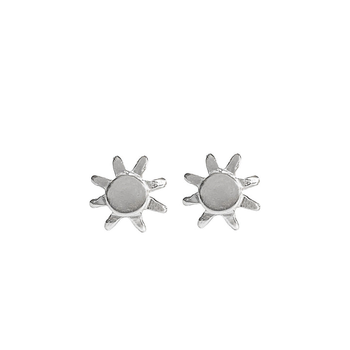 A pair of silver sun-shaped stud earrings with a polished finish, featuring a circular center and delicate rays extending outward. The minimalist yet radiant design makes them perfect for everyday wear or a subtle touch of sunshine-inspired elegance. By Blooming Lotus Jewelry