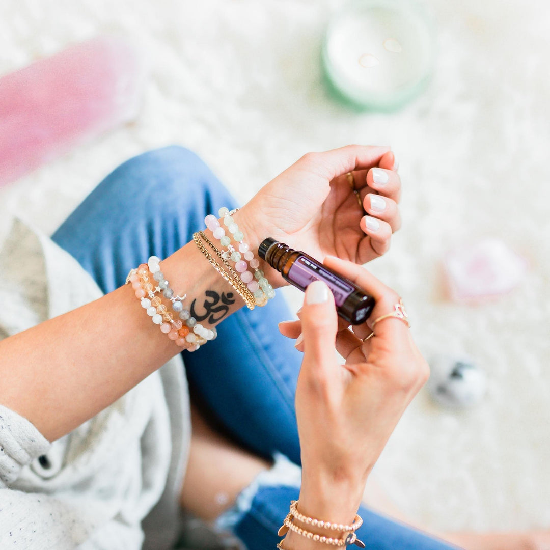 Layering bracelets on model with essential oils crystals - Blooming Lotus Jewelry