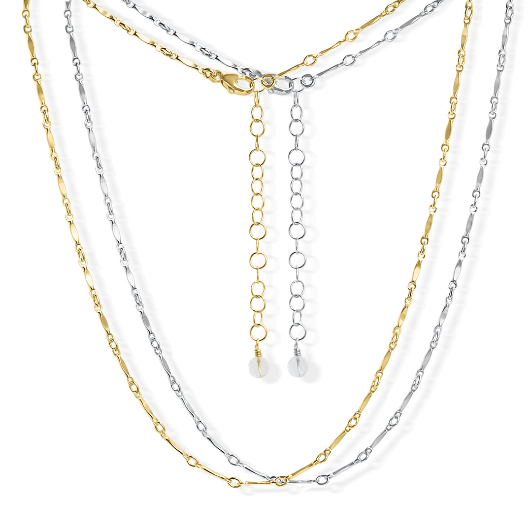 Two Twinkle choker necklaces with minimalist gold and silver chain links featuring tiny, twinkling details. The adjustable clasp and extender chain provide a customizable fit, making it perfect for layering or wearing solo. By Blooming Lotus Jewelry